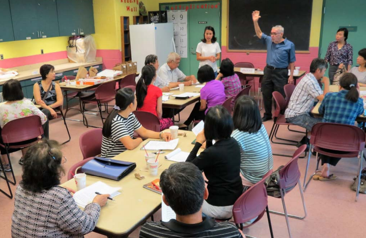 Adult ESOL Students in classroom learning 